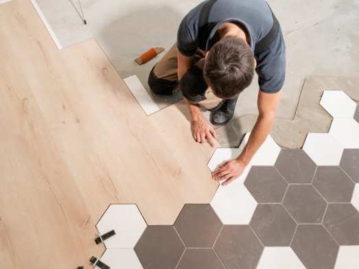 Professional contractor installing  luxury vinyl flooring in Indianapolis, IN